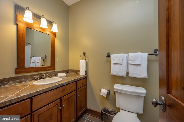 bathroom with tile patterned floors, vanity, and toilet