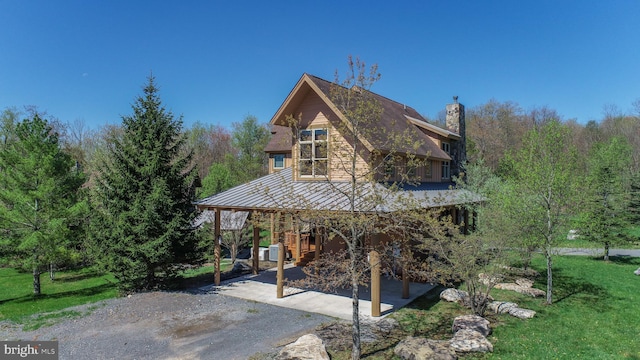 back of property featuring a yard and a patio area