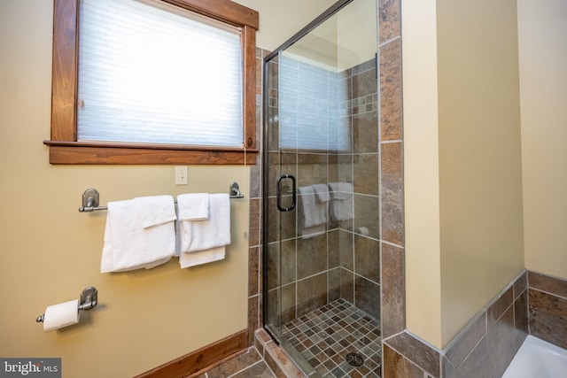 bathroom with a shower with door