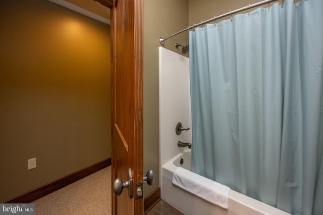 bathroom with shower / bath combo with shower curtain