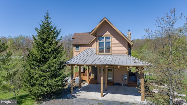 view of front of home with covered porch and central air condition unit