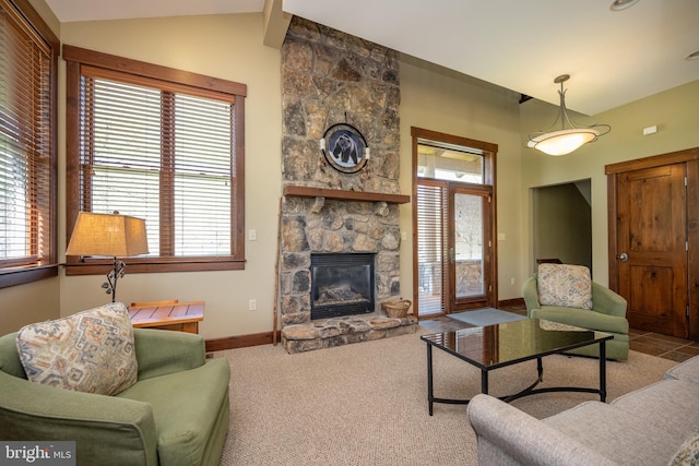 living room with lofted ceiling, a fireplace, and light carpet