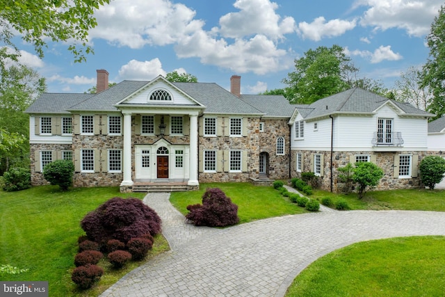 greek revival house with a front yard