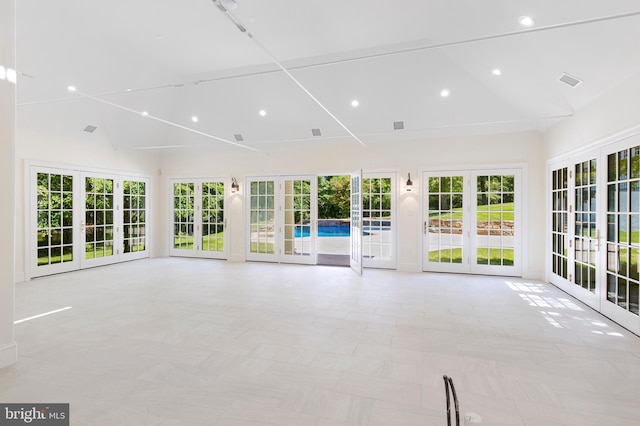 unfurnished sunroom with vaulted ceiling and french doors