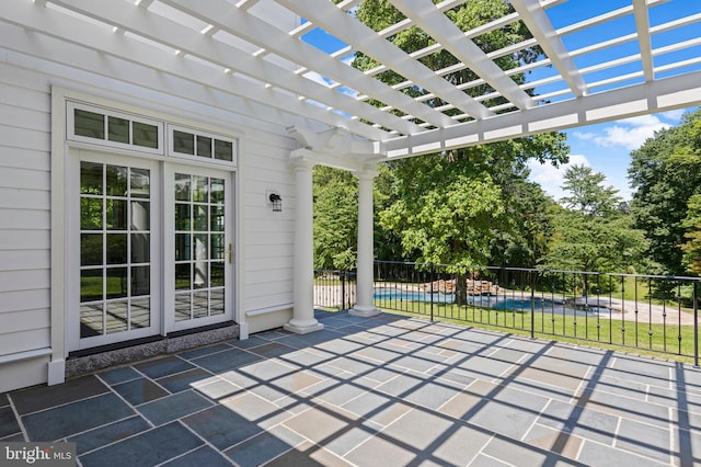 view of patio with a pergola and a pool