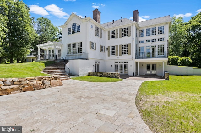 back of house with a pergola, french doors, a yard, and a patio