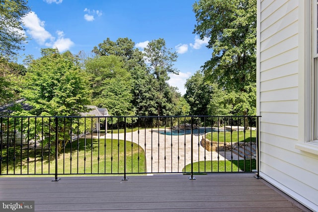 wooden deck with a lawn