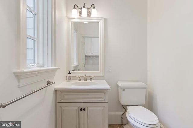 bathroom featuring vanity and toilet