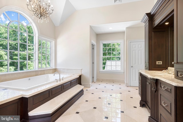 bathroom featuring vanity, vaulted ceiling, tile patterned flooring, a washtub, and a notable chandelier