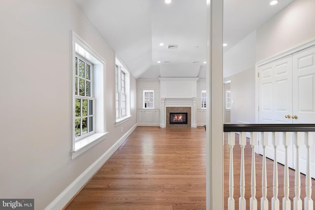 unfurnished living room featuring hardwood / wood-style flooring and vaulted ceiling