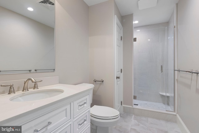 bathroom with vanity, toilet, and a shower with door