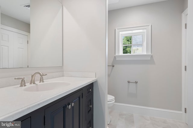 bathroom featuring vanity and toilet