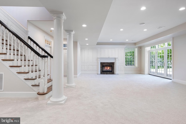 unfurnished living room featuring light colored carpet and a premium fireplace