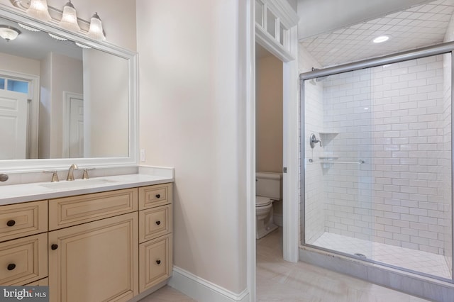 bathroom featuring vanity, an enclosed shower, and toilet