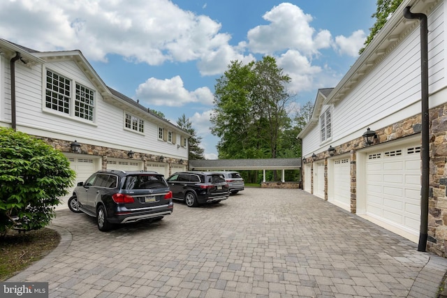 view of vehicle parking featuring a garage