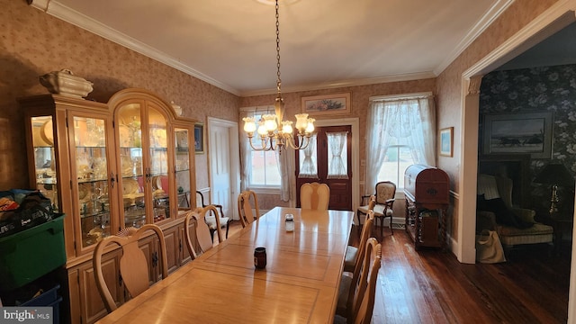 dining room with an inviting chandelier, crown molding, and wood-type flooring