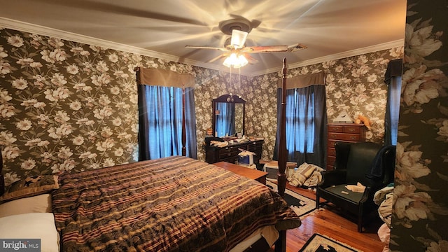 bedroom with ceiling fan, ornamental molding, and hardwood / wood-style floors