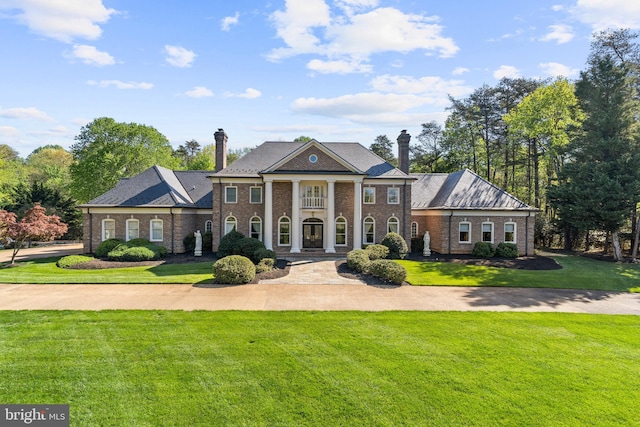 neoclassical home with a front yard