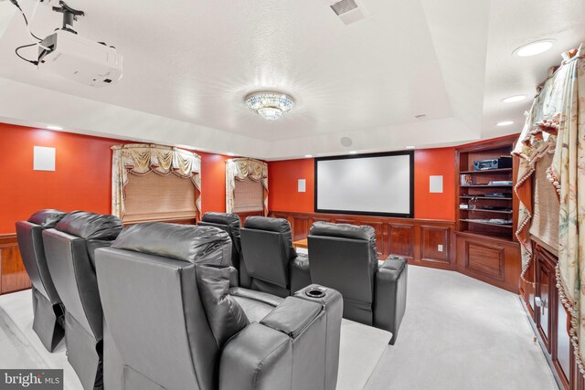 carpeted cinema with a tray ceiling