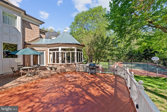 deck featuring grilling area and a sunroom