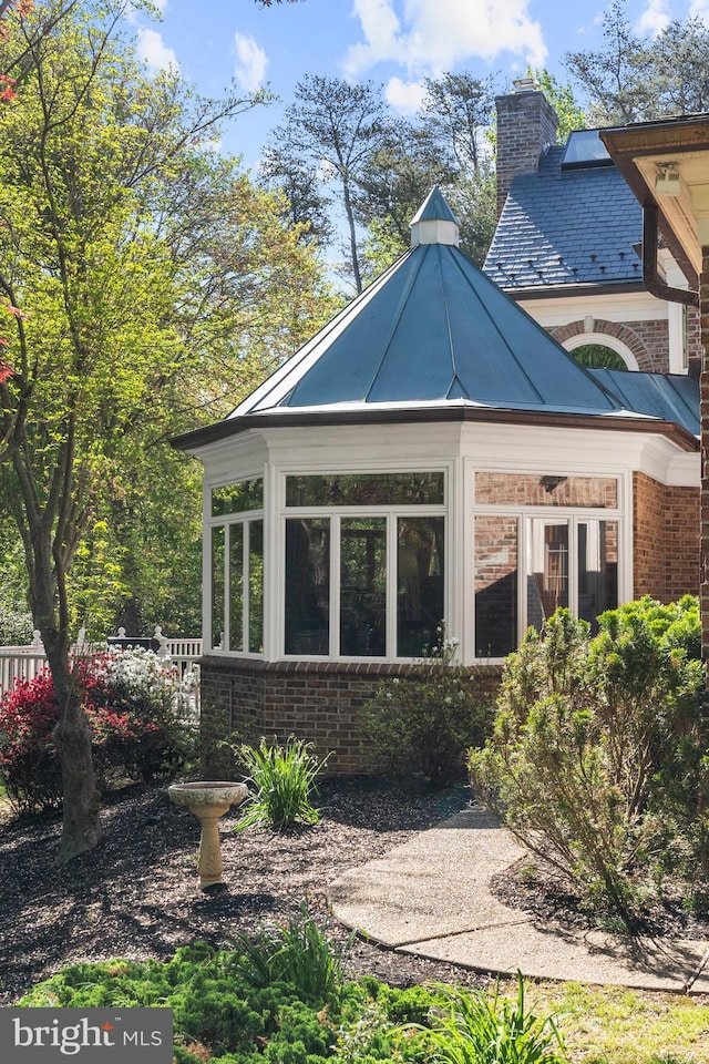 back of house with a sunroom