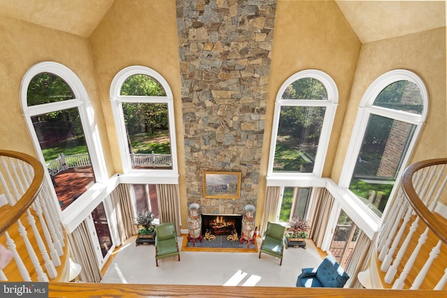 sunroom / solarium featuring plenty of natural light, a fireplace, and vaulted ceiling