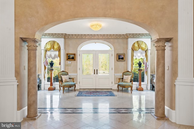 foyer with ornate columns and french doors