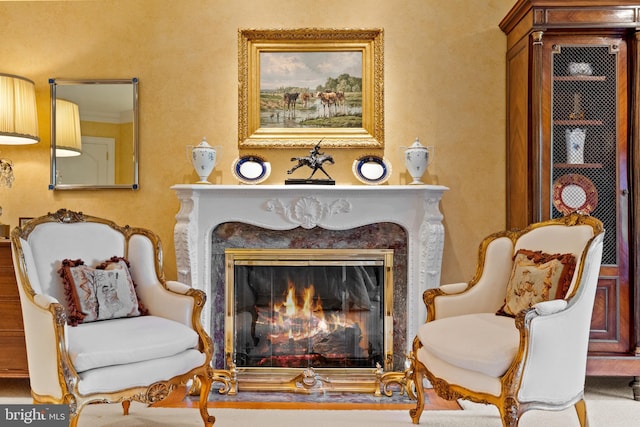 sitting room featuring a premium fireplace and ornamental molding