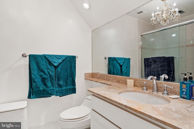 bathroom with vanity, lofted ceiling, a shower with door, toilet, and a notable chandelier