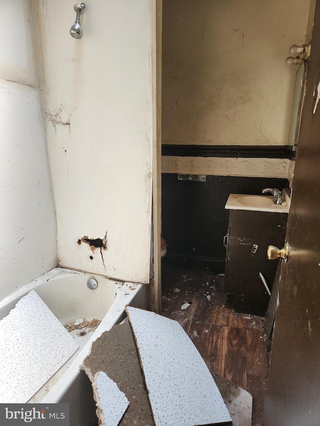 bathroom featuring a tub, toilet, and vanity