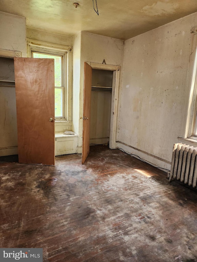 unfurnished bedroom featuring radiator heating unit