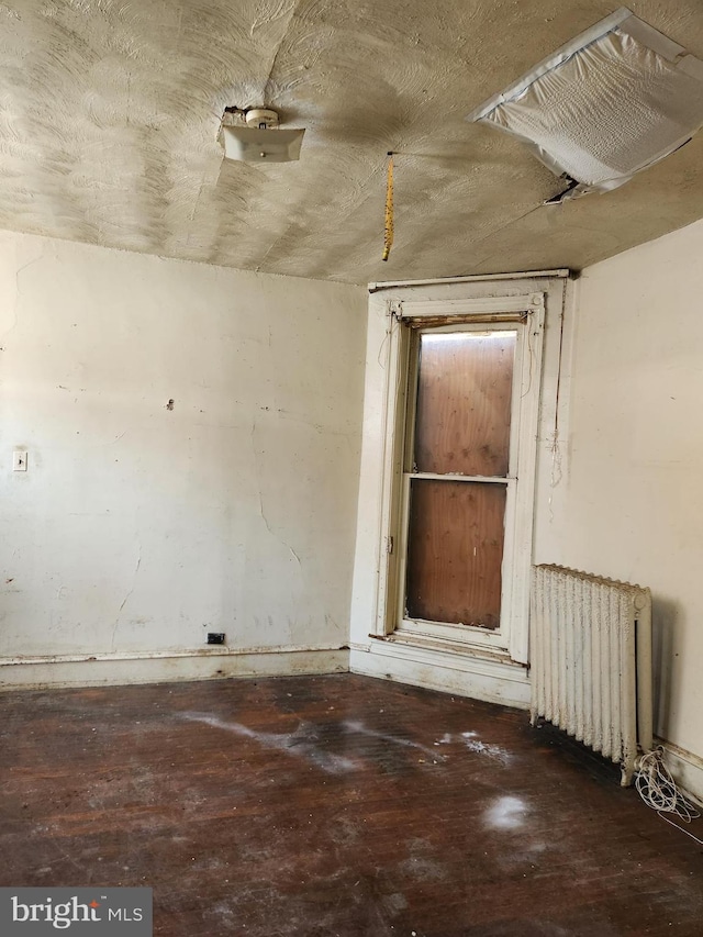 spare room featuring radiator heating unit