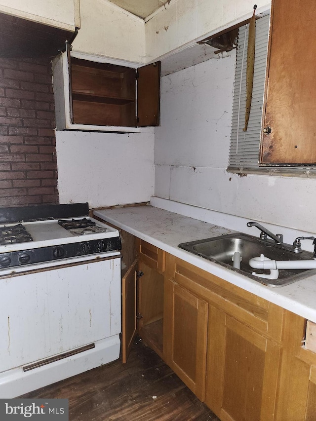 kitchen featuring sink, dark wood-type flooring, and white gas range