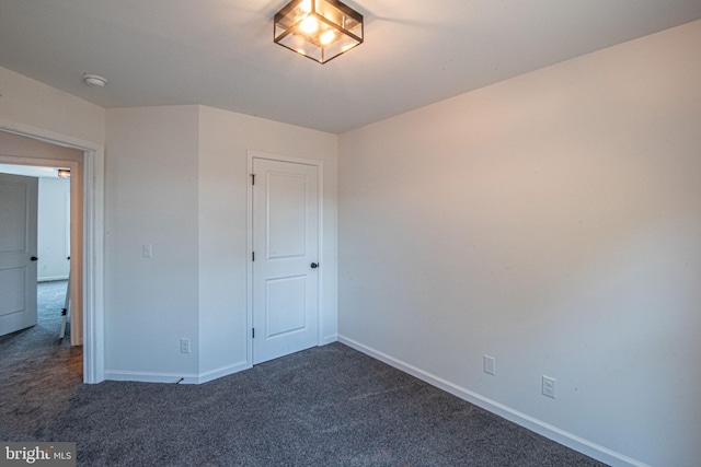 unfurnished bedroom featuring dark carpet