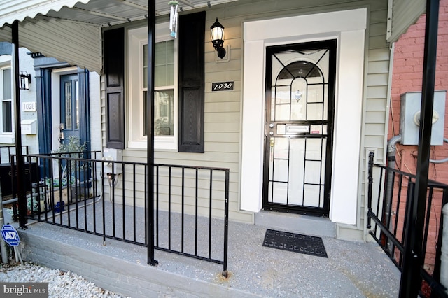 view of exterior entry featuring a porch