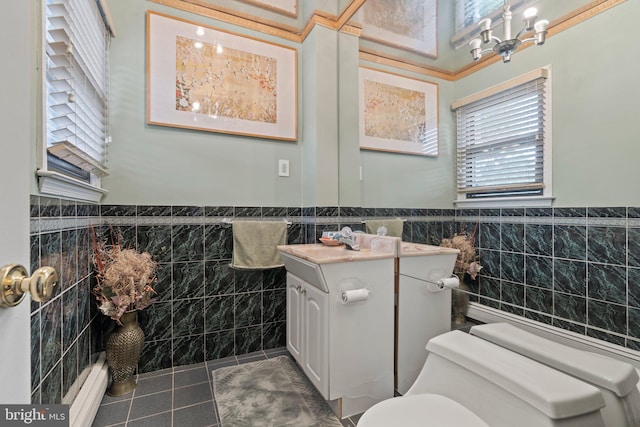 bathroom featuring tile walls, vanity, tile patterned flooring, and toilet