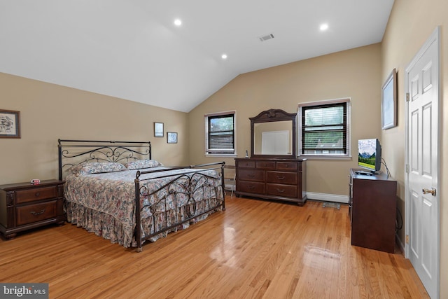 bedroom featuring light hardwood / wood-style flooring and vaulted ceiling