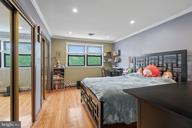 bedroom featuring ornamental molding and light hardwood / wood-style floors