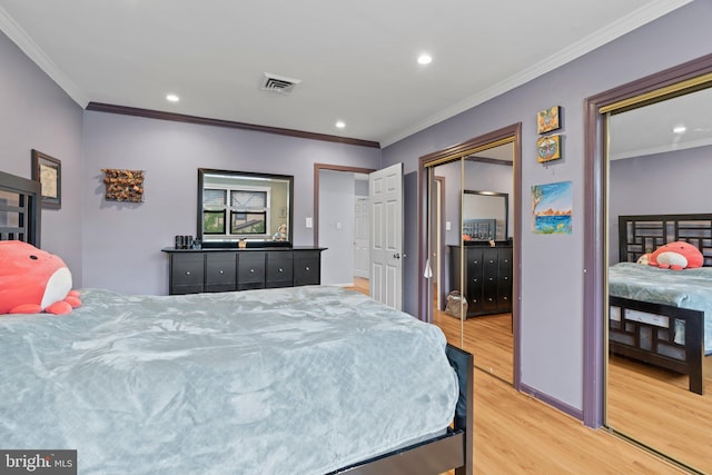 bedroom featuring crown molding and light wood-type flooring