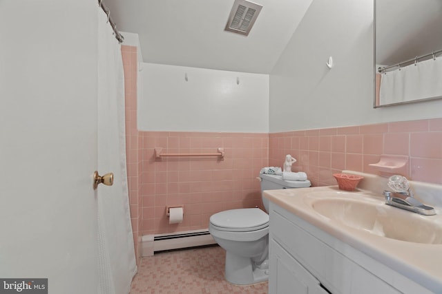 bathroom with vanity, a baseboard heating unit, tile walls, and toilet