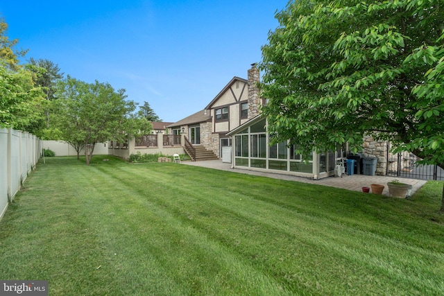 view of yard with a patio area and a sunroom