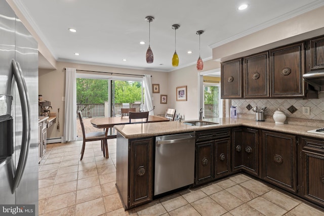 kitchen with sink, hanging light fixtures, stainless steel appliances, a baseboard radiator, and kitchen peninsula