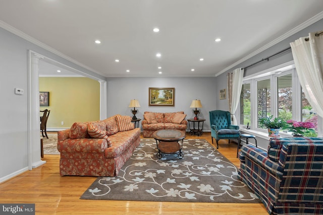 living room featuring ornamental molding and light wood-type flooring