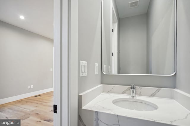 bathroom featuring hardwood / wood-style floors and oversized vanity