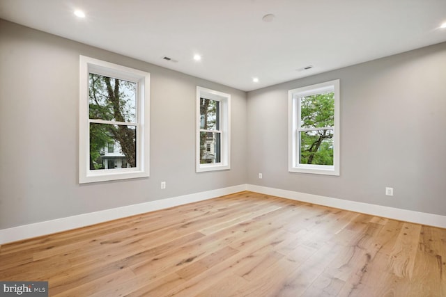 empty room with light hardwood / wood-style flooring