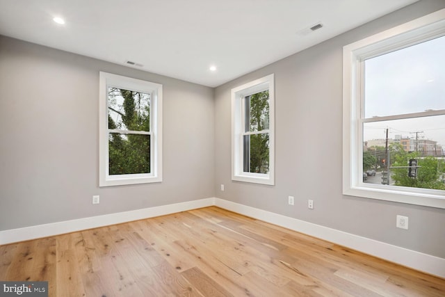 spare room with light hardwood / wood-style flooring