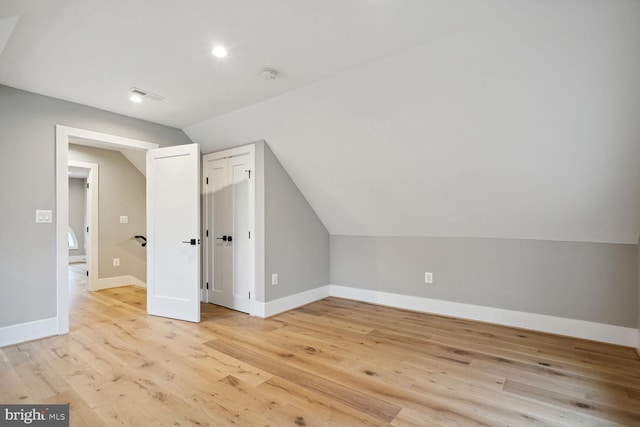 bonus room with light hardwood / wood-style flooring and lofted ceiling