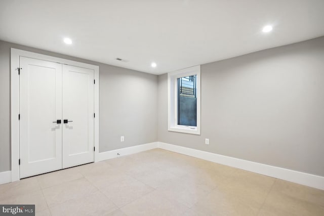 unfurnished bedroom featuring a closet and light tile floors