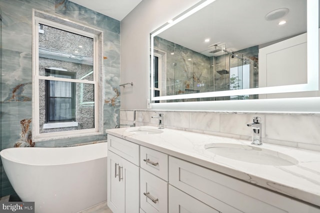 bathroom featuring dual vanity, walk in shower, and tile walls