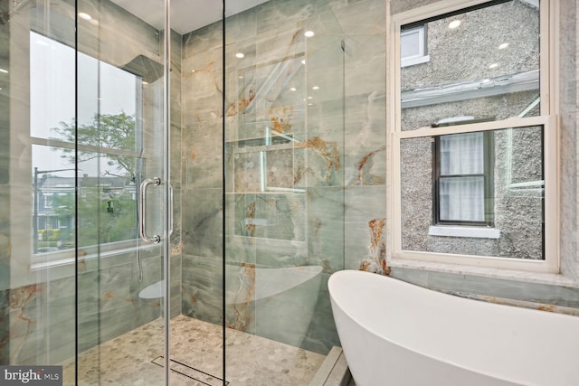 bathroom with tile walls and separate shower and tub